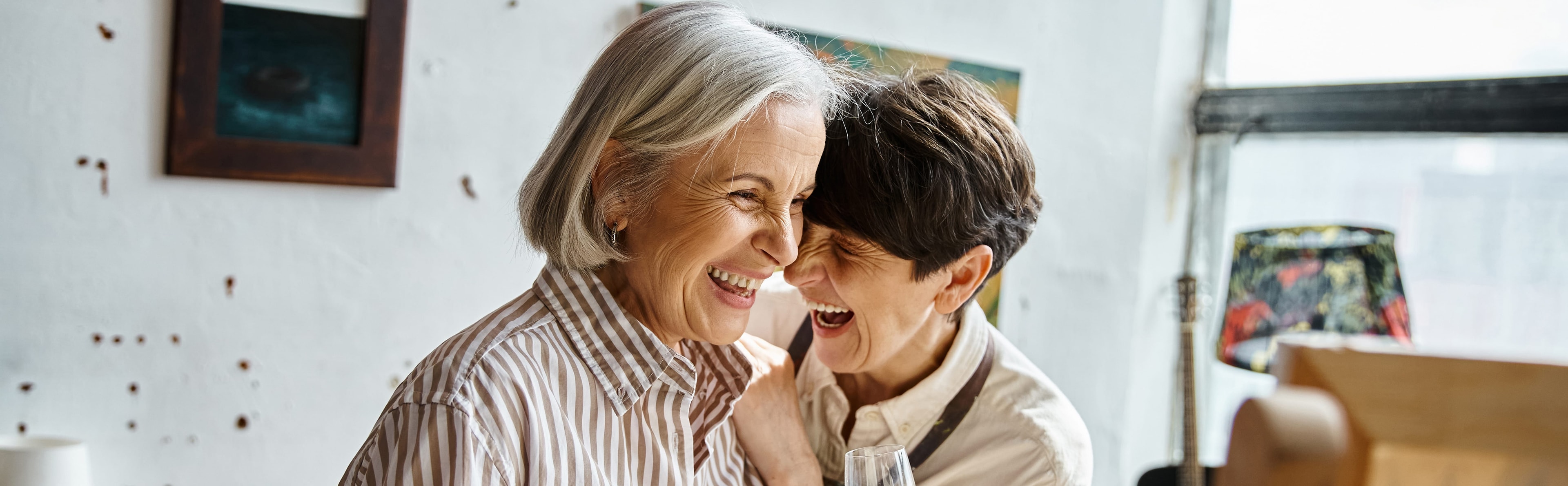 Two women laughing together, sharing stories